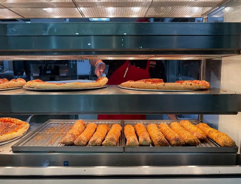 Close up view of Costco food court pepperoni pizza from the tray rack ready for ordering